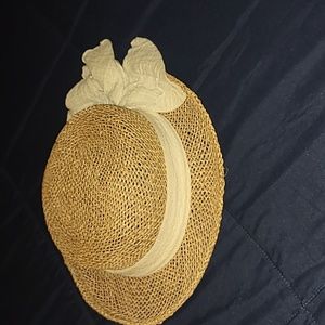 Straw colored hat with beige bow on the back. OS fits all.